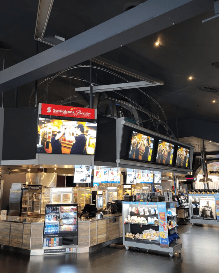 Professional digital signage display in a movie theatre lobby